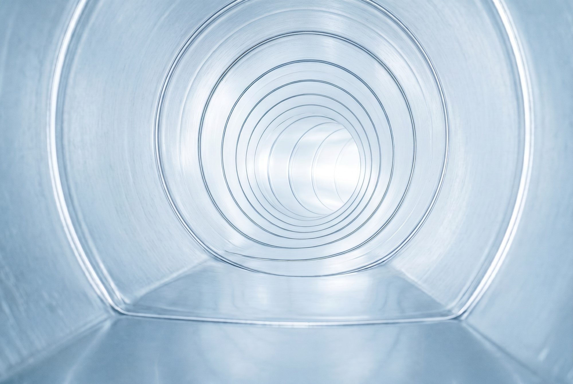 Inside of an air duct after professional cleaning — bright, clean metal